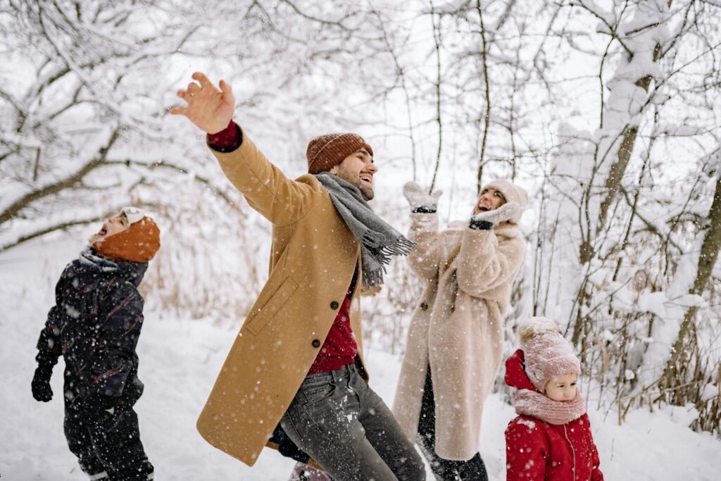 Happy family enjoying a snowy day in winter