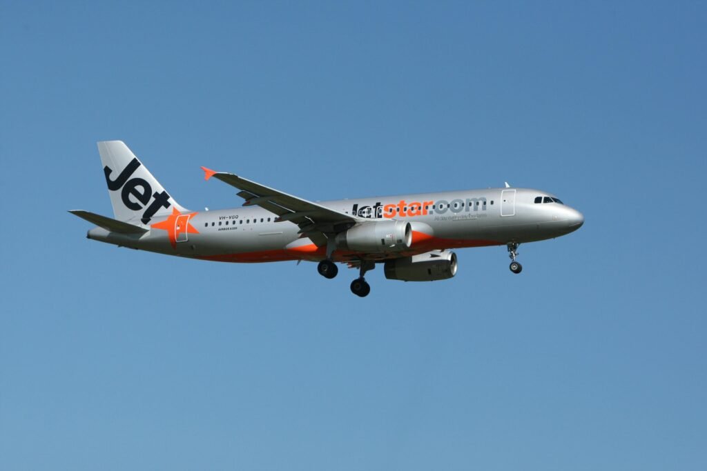 aircraft flying against a clear blue sky. Captured outdoors.